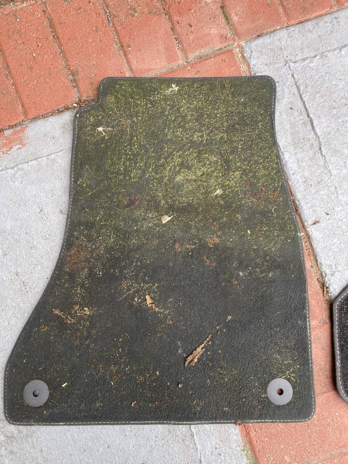 Dirty vehicle mat before professional cleaning