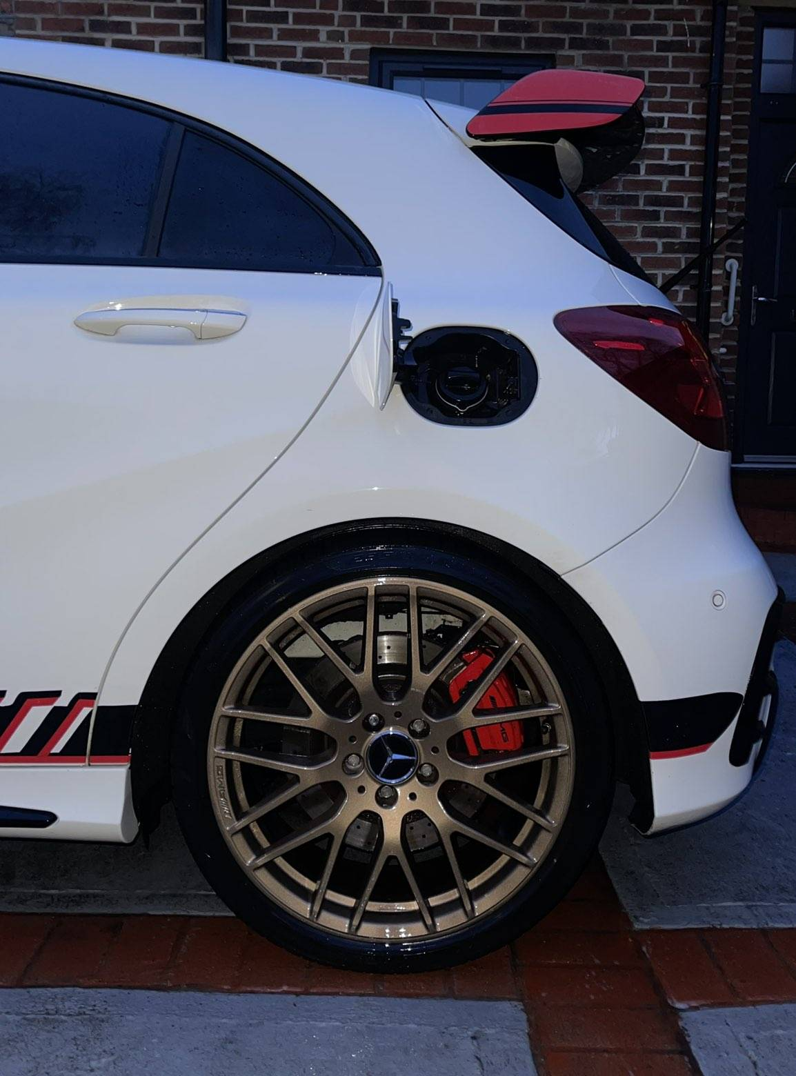 Rear wheel and bodywork of white Mercedes after detailing